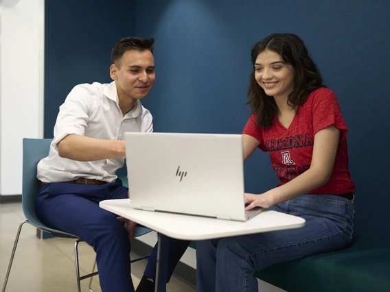 Student and advisor looking at laptop together