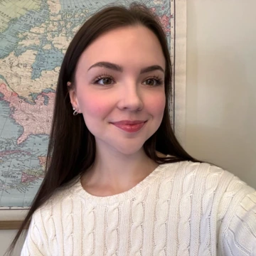 Charlotte McTaggart smiling in front of map