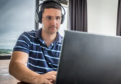 Photo of online student working on laptop